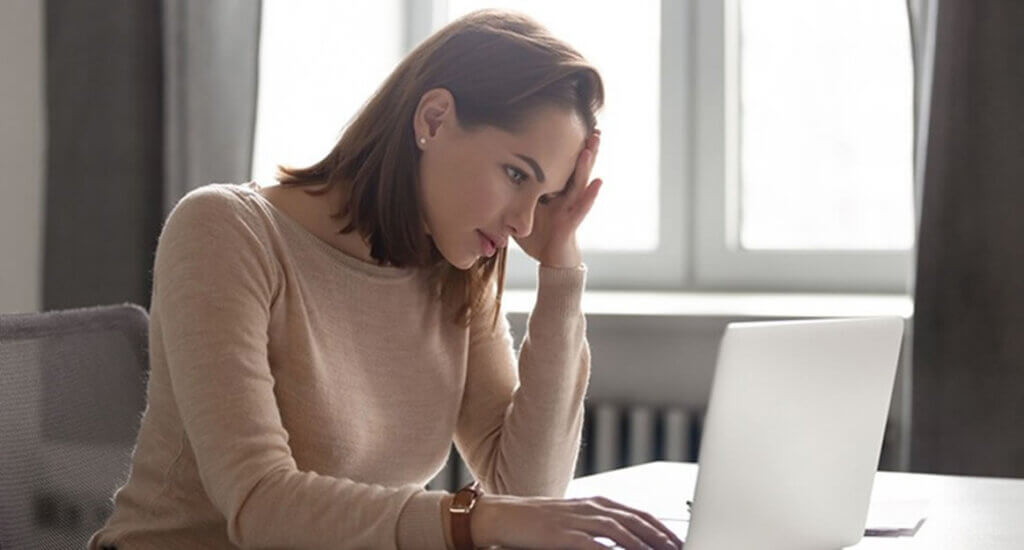 stressed woman looking at sales numbers