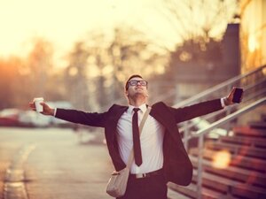 happy sales person outside with arms spread