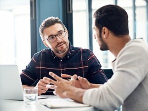 sales professionals talking at desk